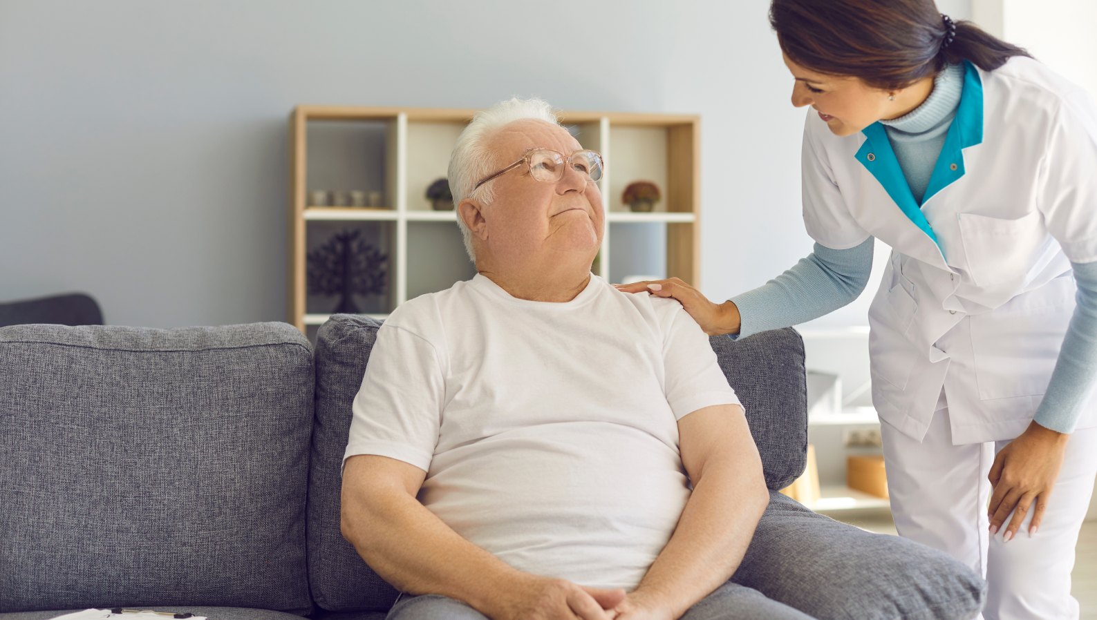 A friendly nurse visiting a senior at home after hospital discharge