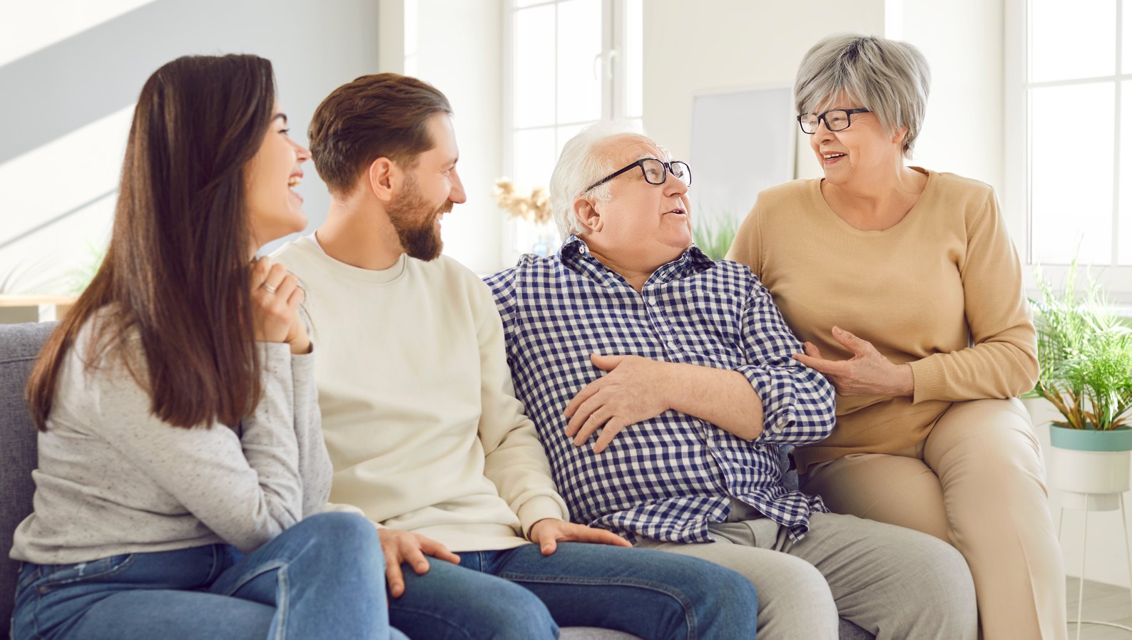 A happy family with aging parents and adult children together at home