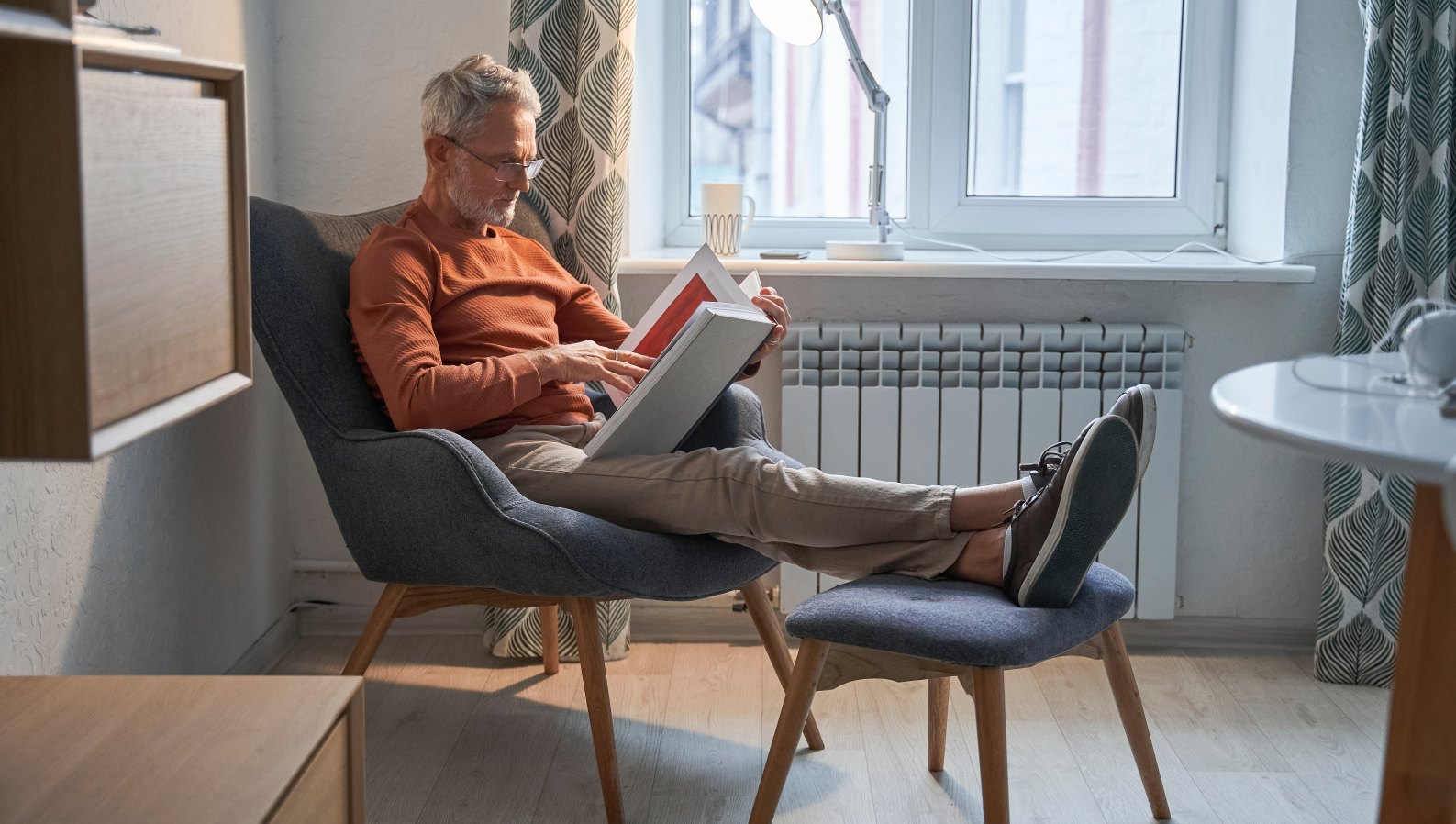 A senior man relaxing comfortably in his favorite armchair at home