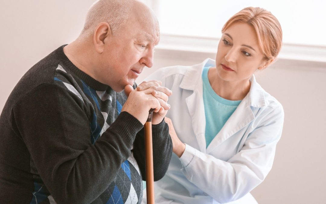 A caregiver providing gentle memory care to a senior in his own home